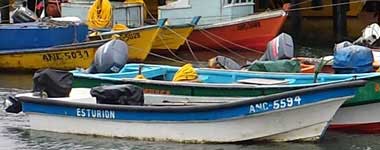 A photograph of colorful artisanal fishing boats.