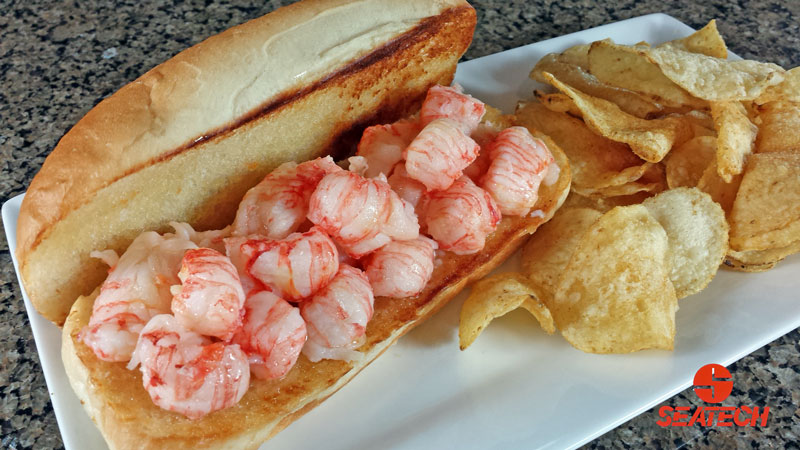 A photograph of a butter boached langostino lobster roll.