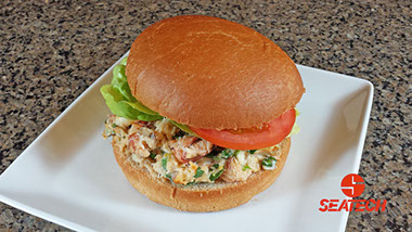 A photograph of a crab burger featuring Seatech Chilean crab meat.