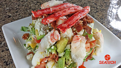 A photograph of a Chilean king crab COBB salad.