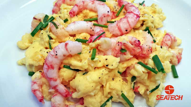 A photograph of Chilean shrimp scrambled eggs with chives.