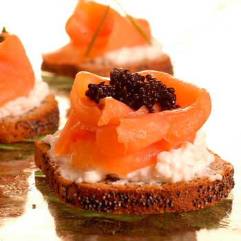 A photograph of cold smoked salmon on toast with caviar.