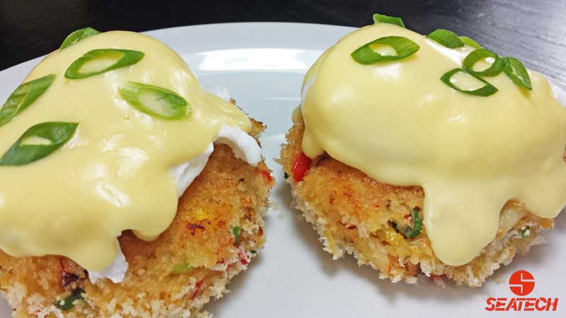 A photograph of crab cakes coated with Panko breading and fried in butter until crispy and golden.