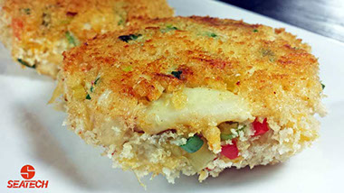 A photograph of crab cakes coated with Panko breading and fried in butter until crispy and golden.