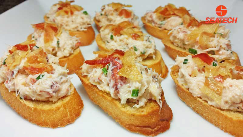 A plate with crab bruschetta topped with crisp pancetta.