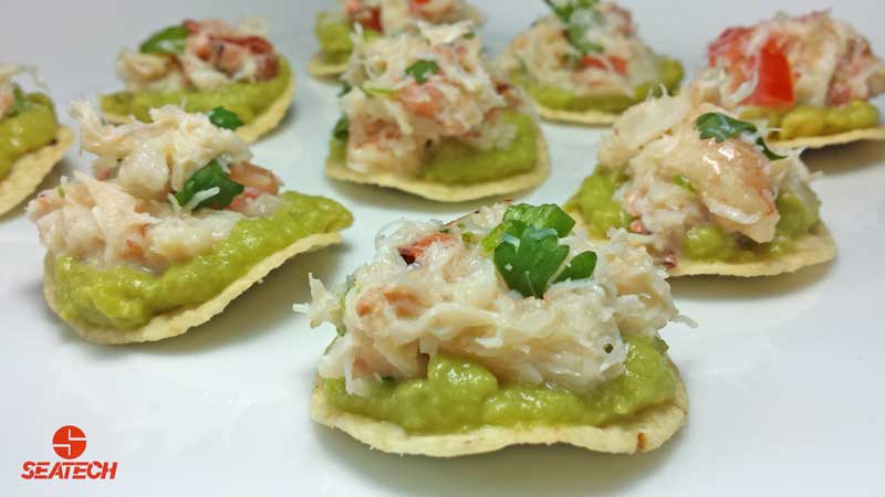 Round tortia chips with a layer of guacamole and than topped with crab ceviche.