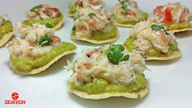 Round tortia chips with a layer of guacamole and than topped with crab ceviche.