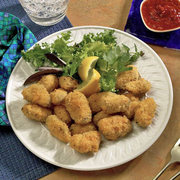 Photograph of panko breaded fried mussels with cocktail sauce to go along with the recipe on this webpage.