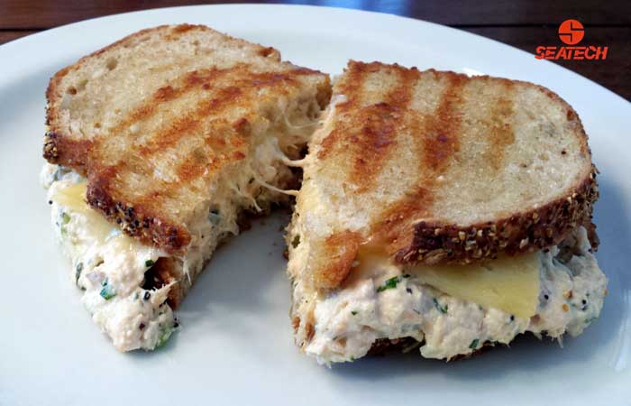 A photograph of a classic salmon salad sandwich.